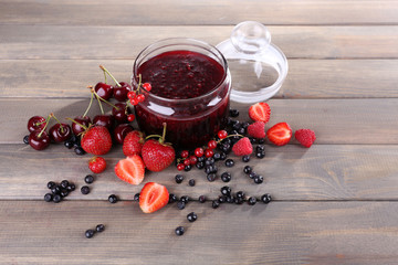 Berries jam in glass jar on table, close-up © Africa Studio