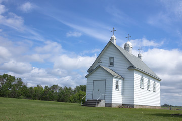 Little white church on the Prairie countryside.