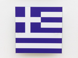 Greece flag on a plastic plate made in the form of decoration