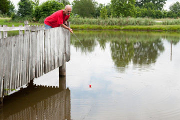 Man fishing on pier