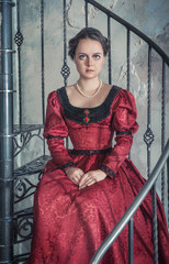 Beautiful woman in medieval dress on the stairway
