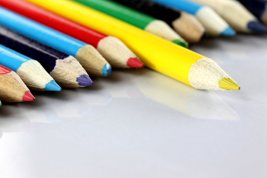 Several colored of crayon is arranged on white.