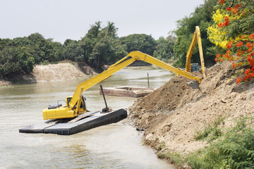 excavator machine group works at river for protect flood
