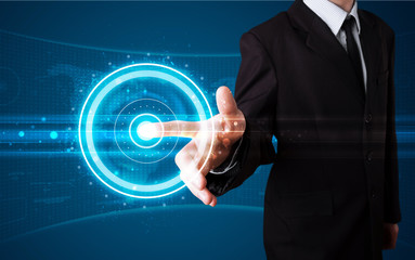 Businessman pressing high tech type of modern buttons