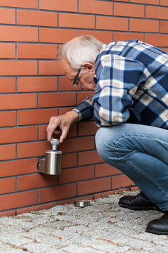 Man Changing The Light Bulb Outside