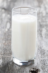 glass of milk or kefir on a wooden table