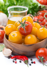 yellow and red cherry tomatoes, olive oil and spices, close-up