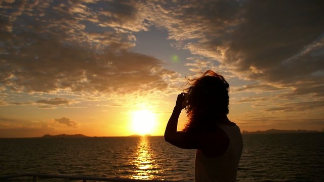 Girl Photographing Sunset from Sailing Ferry. Motivational