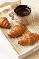 Breakfast table with  croissant and coffee cup