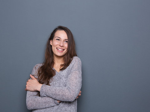 Young woman laughing with arms crossed