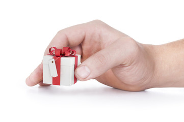 female hand holding red and white gift box with a bow