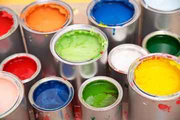 Bunte Farbdosen auf Parkettboden