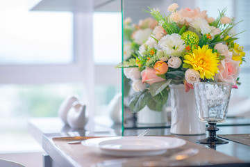 Colorful rose flower in vase on dinning table