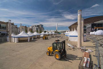 Workmen setting up static tents for a public festival in Cardiff