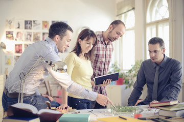 Group of Architects with teacher working at project