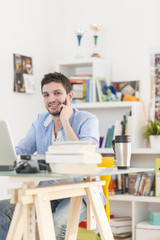 young student works on his laptop at home