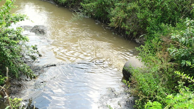 Water pollution. Waste water flowing and polluting environment. 