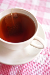 close up red english tea in white cup