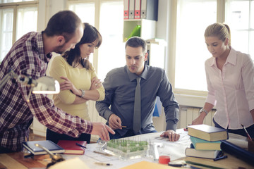 Group of Architects Sitting Around Table Having Meeting