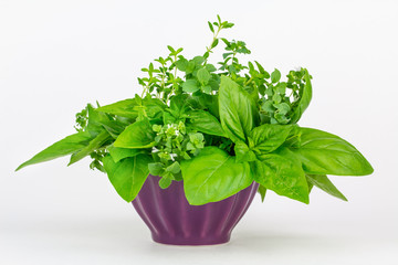 Fresh herbs in a bowl: thyme, oregano and basil