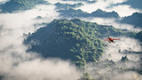 Red airplane flying over mountains with pine trees in the clouds