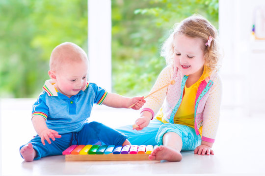 Happy kids playing music with xylophone