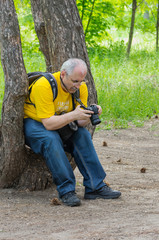 Enthusiastic mature photographer scanning resent photos