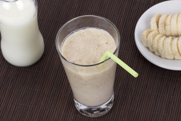 Banana milkshake on bamboo mat background