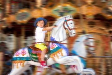 Cute kid, riding on a carousel