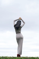 Young woman in sexy long gray dress