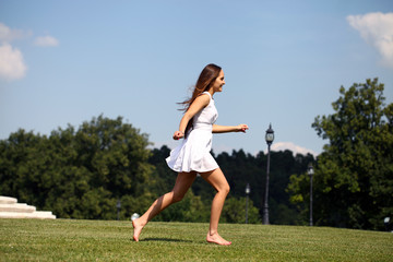 Happy young woman in sexy white dress