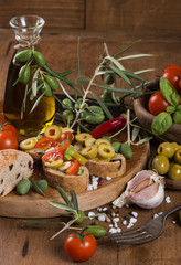 Olive bread with olive oil, spices and  cherry tomatoes on old w