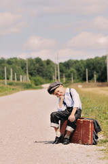young tired traveller sitting on the road