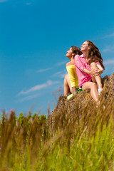 two young happy women on natural background