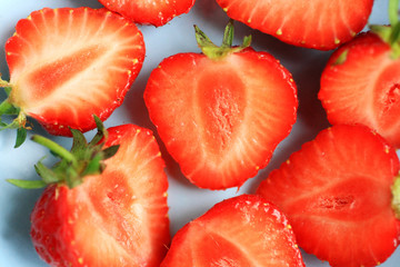 Fresh strawberries in a blue bowl, close up