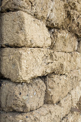 Corner of the wall of adobe bricks - Mud wall texture.