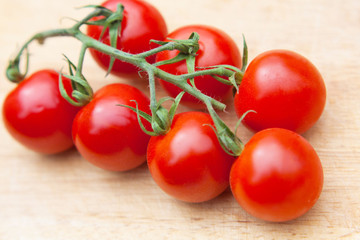Cherry tomatoes on wooden table close up