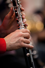 Fototapeta premium Human hands playing a clarinet closeup
