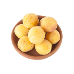 Ripe Apricots in clay bowl isolated on white