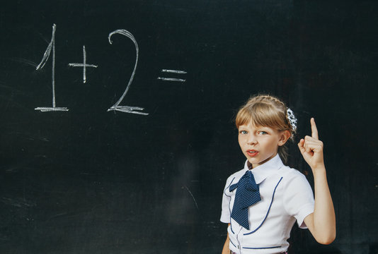 happy school girl on math classes finding solution and solving p