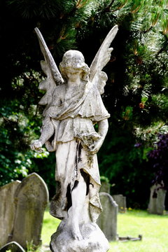 statue of woman angel in graveyard