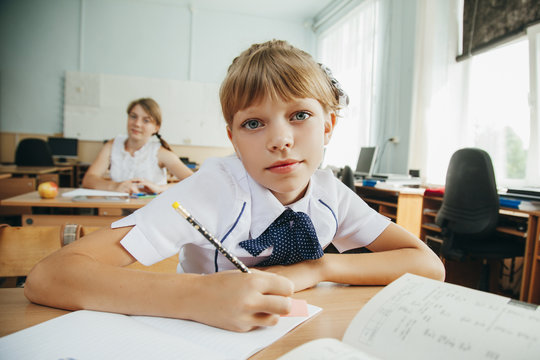 Portrait of a cute schoolgirl in a classroom.