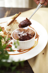 close up chocolate cup cake with caramel sauce and spoon