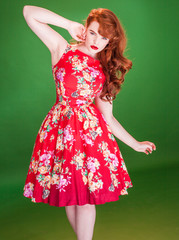 Red haired woman wearing a red summer dress
