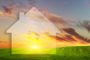 Vision of a new house on green field at sunset. Real estate
