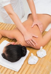 Fototapeta na wymiar Woman enjoying a herbal compress massage