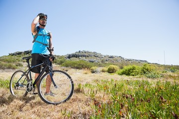 Obraz premium Fit cyclist riding in the countryside looking around