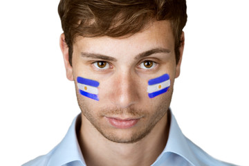 soccer fan with argentina flag painted at the face