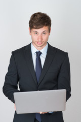 handsome businessman holding a laptop