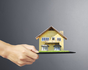 house on tablet in hands